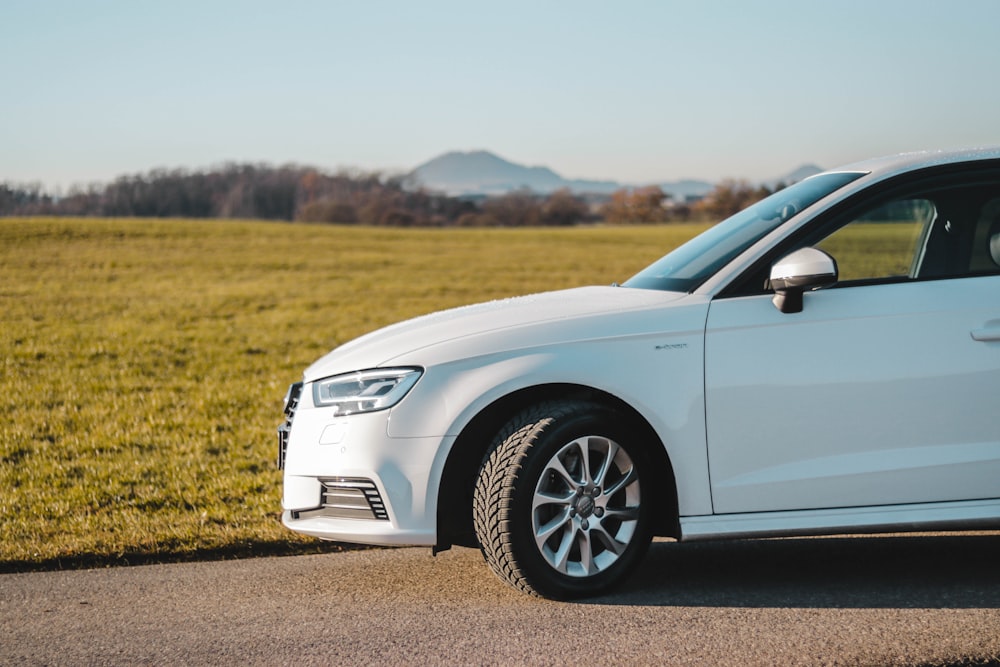 white car on brown field during daytime