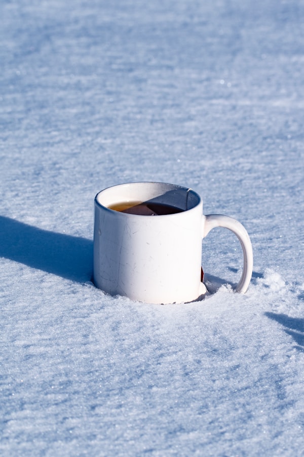 White ceramic mug on white snow
