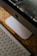 A close-up view of an Apple iMac computer monitor and keyboard setup on a wooden surface. The focus is on the sleek design and clean lines of the Apple hardware, with the Apple logo visible on the monitor. The keyboard is an Apple Magic Keyboard with a white finish, reflecting minimal and tidy aesthetics.