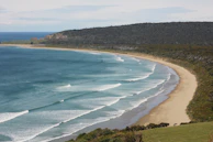 A sweeping bird's-eye view of Parangtritis Beach waves crashing against the shore.