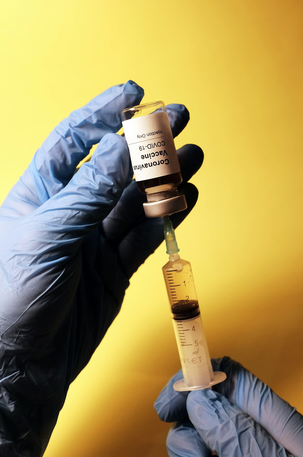 person holding white and black labeled bottle