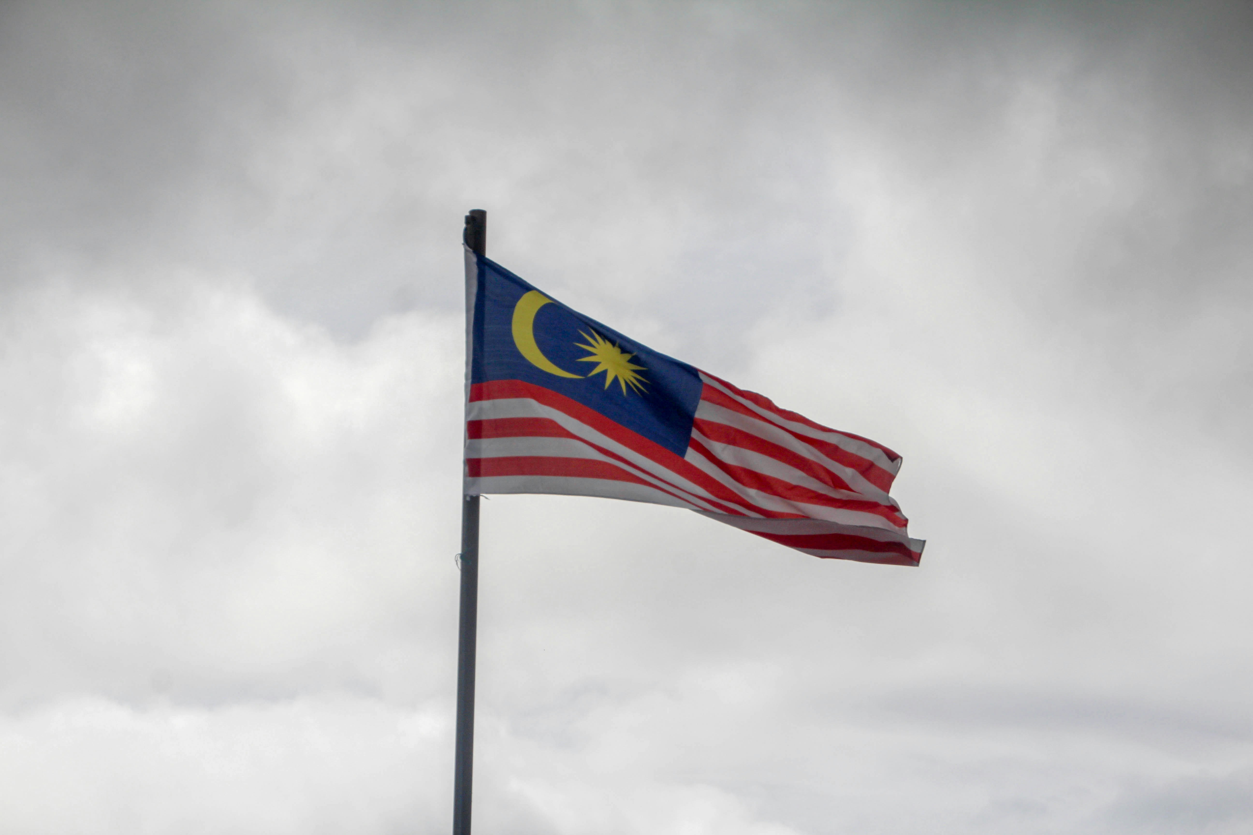 red blue and white flag under white clouds