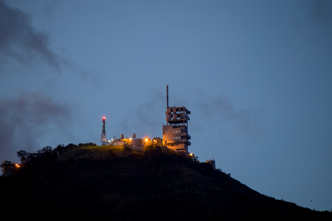 white and black tower on top of hill