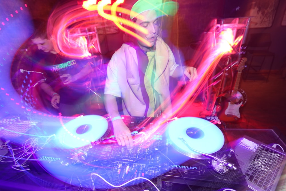 DJ 믹서를 연주하는 하얀 드레스 셔츠를 입은 남자