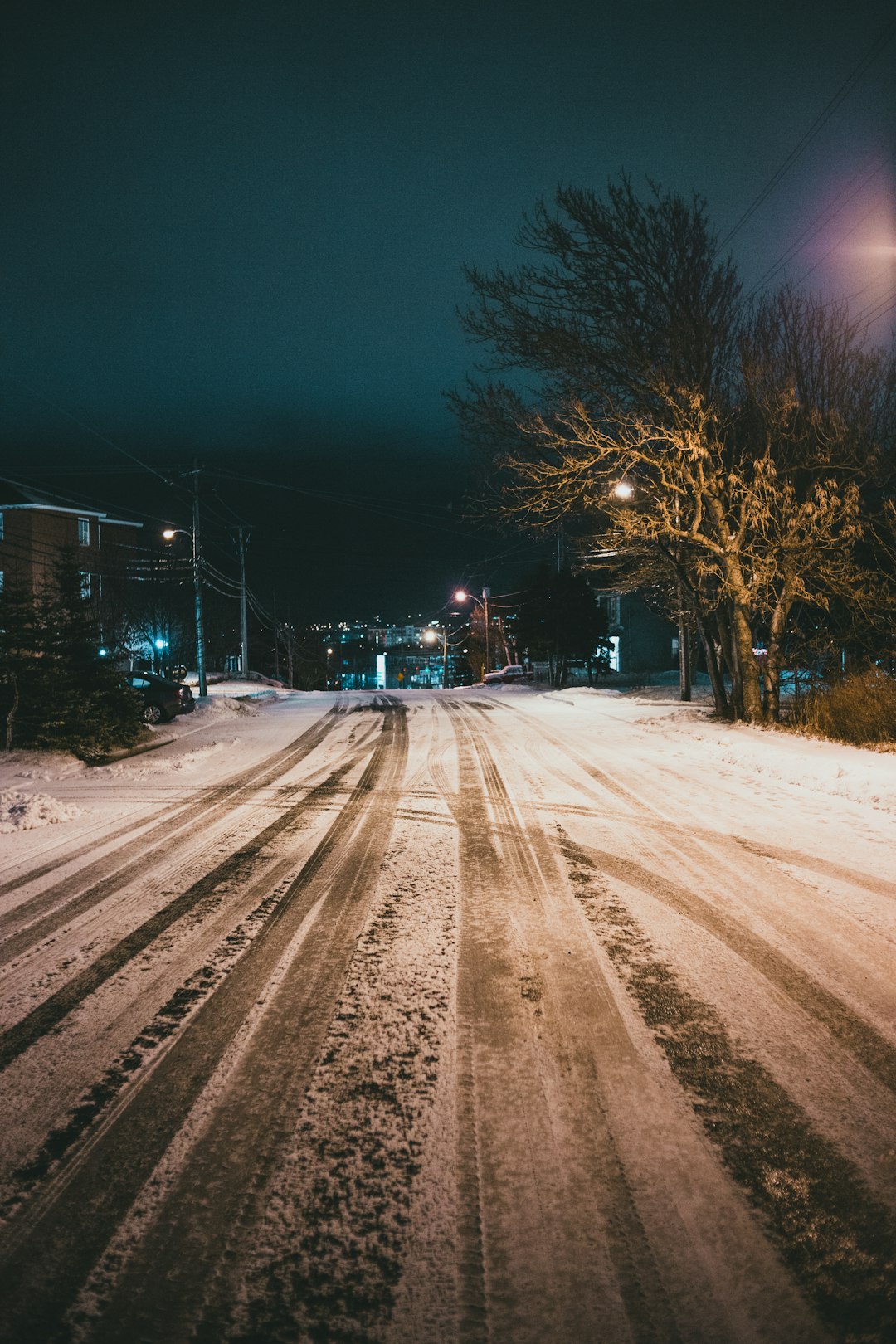 snow covered road during night time