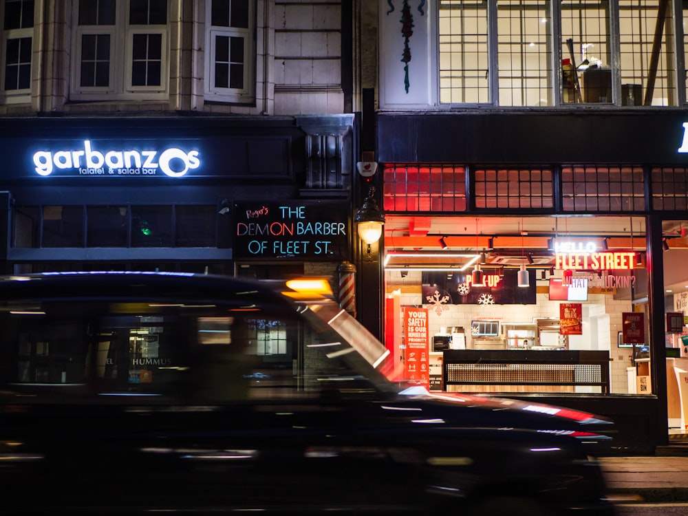 cars parked in front of store during night time