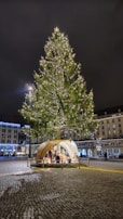 The illuminated nativity scene set up in the central plaza during the evening.