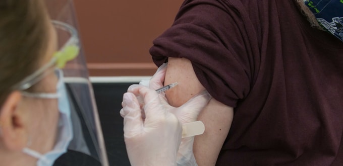 person in brown long sleeve shirt with white bandage on right hand