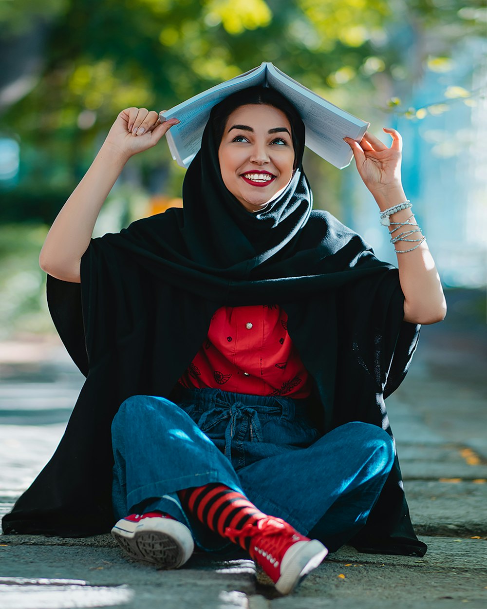 woman in black hijab and red white striped long sleeve shirt