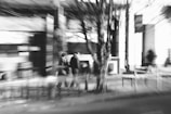 A close-up street photo capturing candid moments with a gentle blur effect.