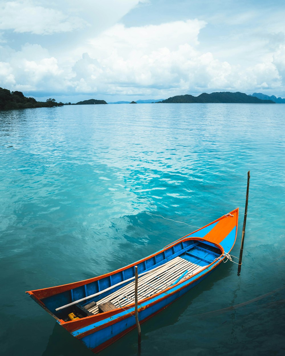 blue and brown boat on sea during daytime