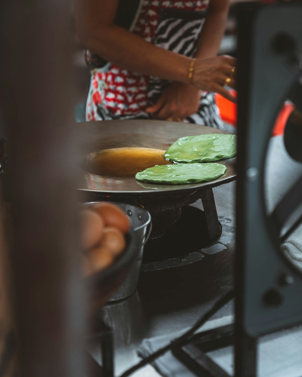 woman in black and white polka dot shirt cooking