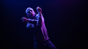 A bold, detailed full-body character design with dynamic pose and vibrant colors against a dark background