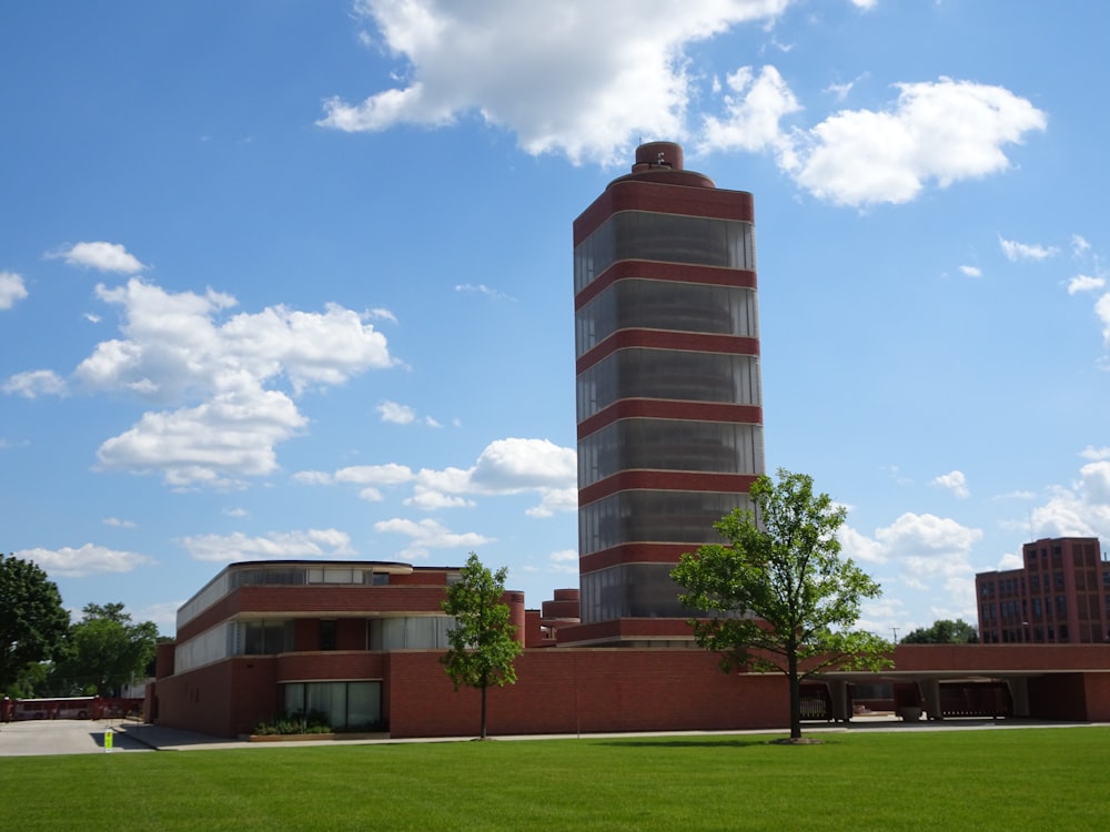 brown and white concrete building near green grass field under blue sky during daytime