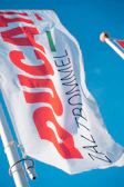 Close-up of a sleek, professionally printed advertising flag with bold branding.