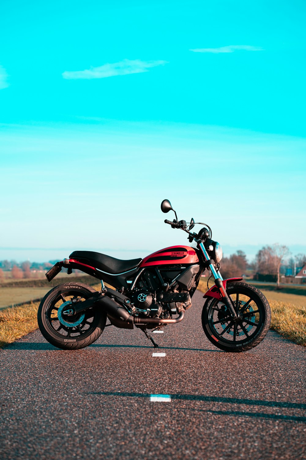 black and red cruiser motorcycle on road during daytime