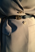 black leather belt on gray textile