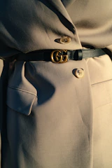 black leather belt on gray textile