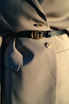 black leather belt on gray textile