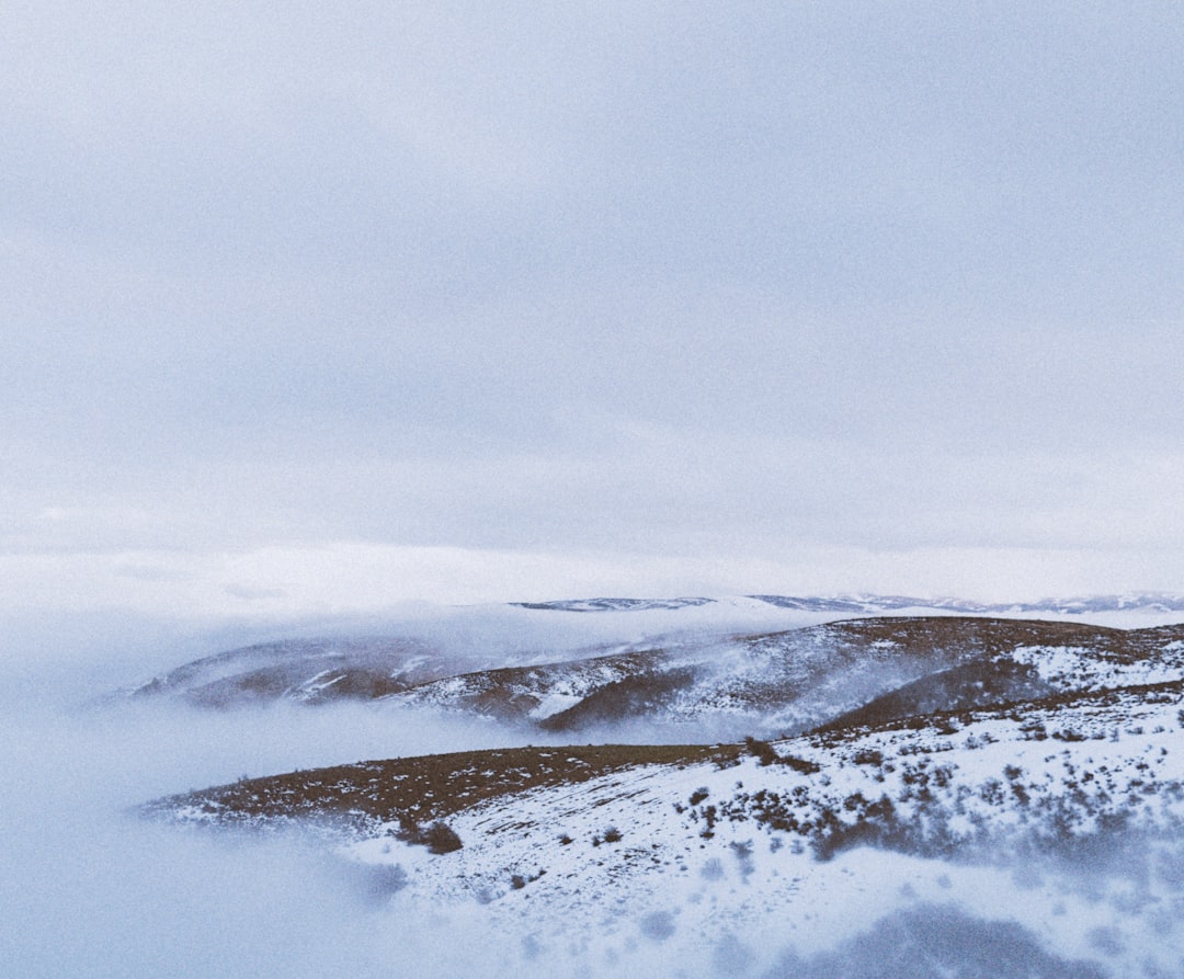 snow covered mountain under cloudy sky during daytime