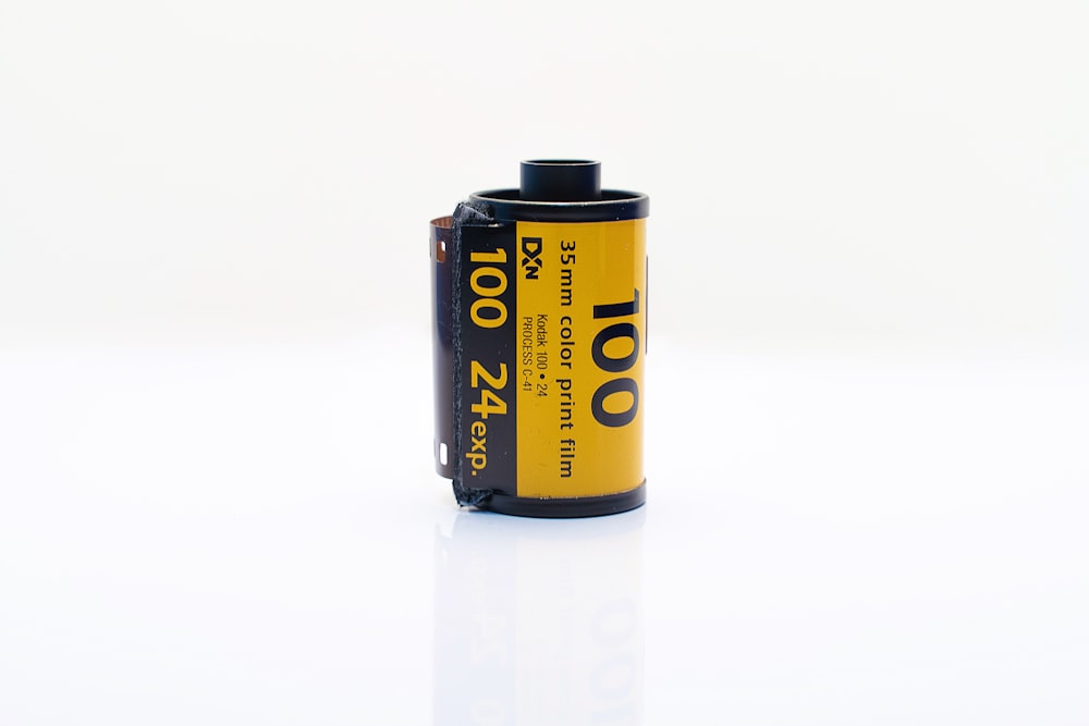 a yellow and black battery on a white surface
