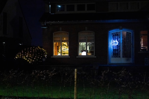 A cozy San Diego home glowing warmly with Frostys Lighting's Christmas lights at dusk.