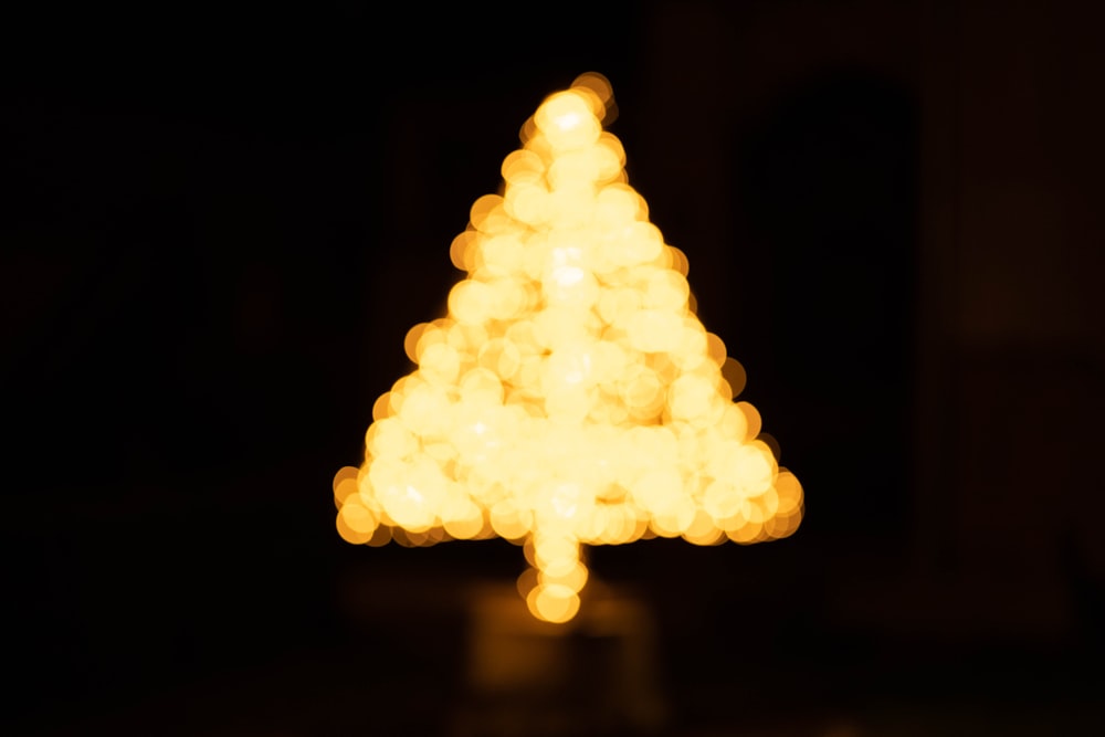 yellow lighted christmas tree during night time