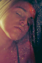 Soft-focus image of a person in meditation, bathed in warm, golden light.