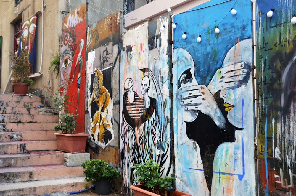 woman in black and white stripe shirt and blue denim jeans graffiti