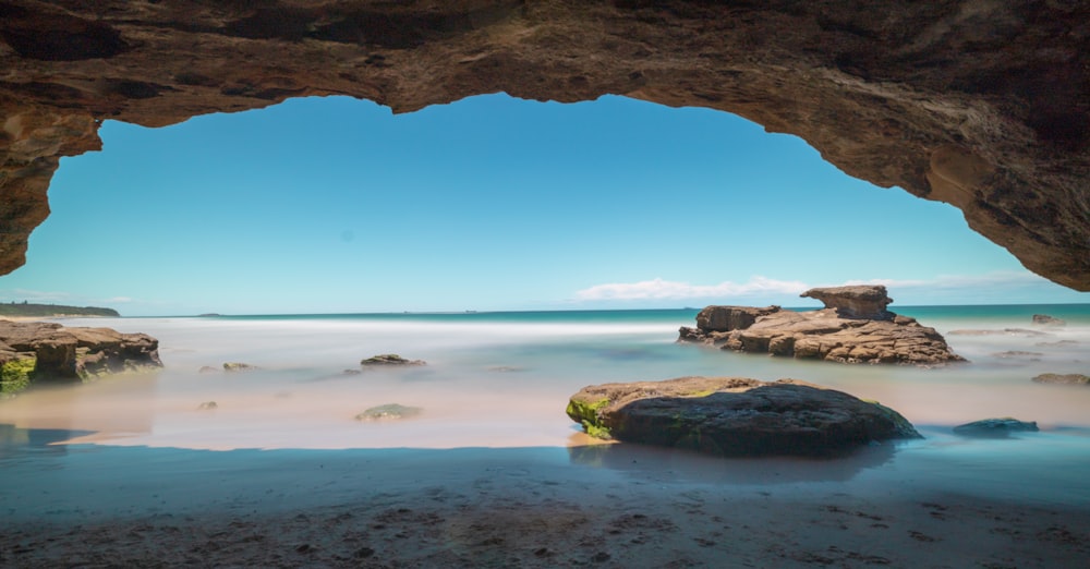 brown rock formation near body of water during daytime