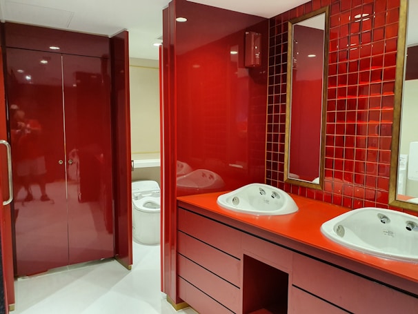 Close-up of a custom bathroom vanity with reddish-pink accents reflecting the brand's signature style and high craftsmanship.