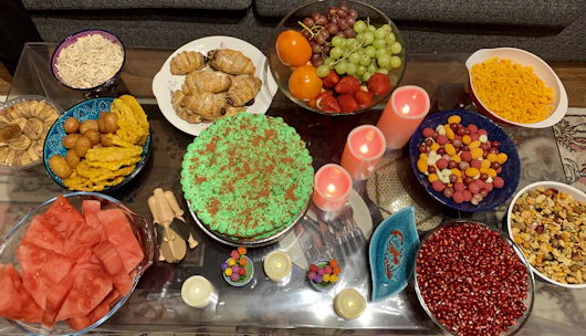 A lively birthday party table featuring an assortment of snacks and a decorated cake.