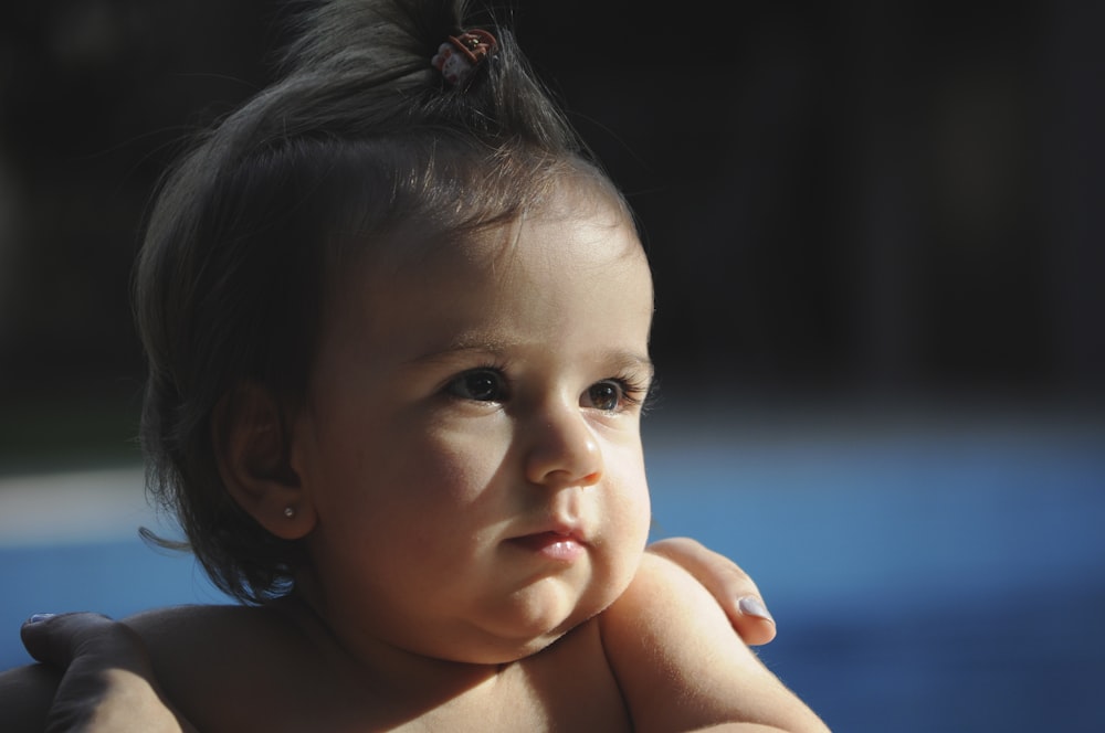 topless child with brown hair