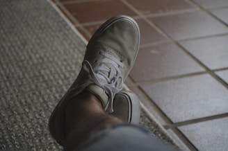 person wearing gray nike sneaker