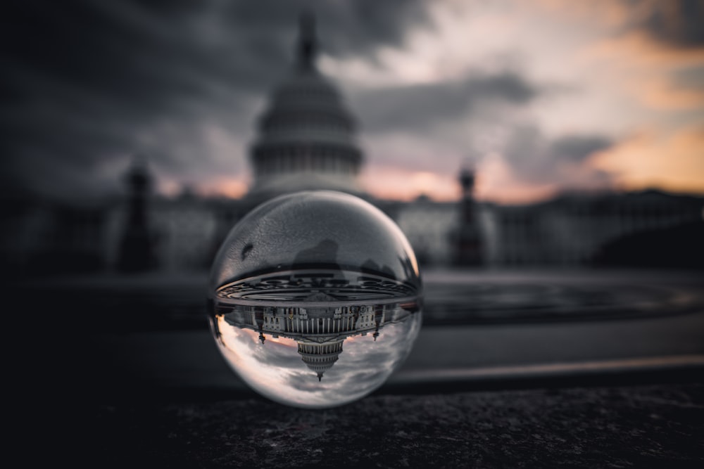 clear glass ball on black asphalt road during daytime