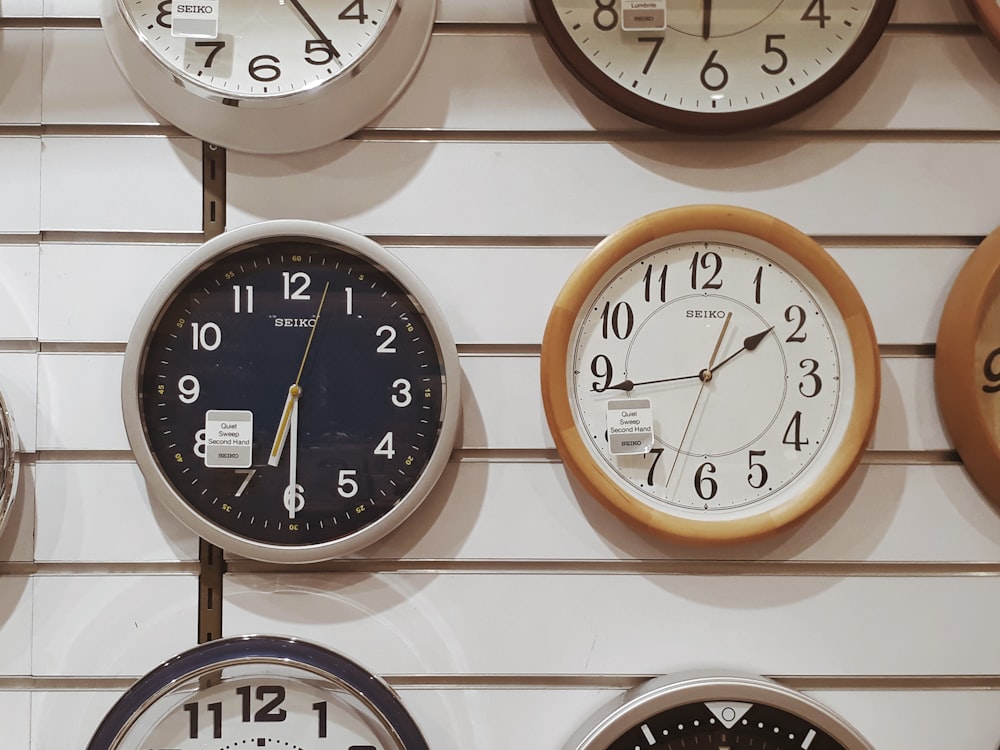 white and black analog wall clock at 10 00