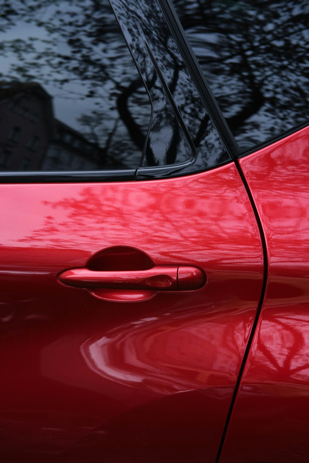 red car with black and white snow