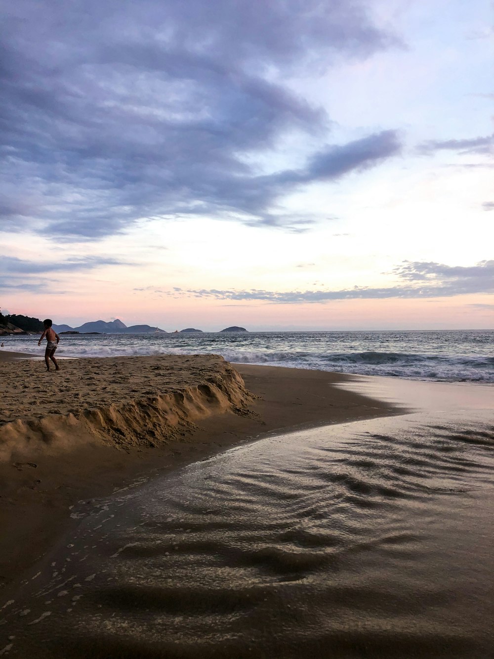 2 person walking on beach during daytime