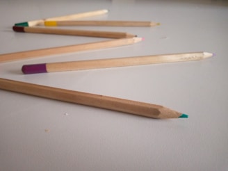 A variety of no point pencils displayed in a handcrafted wooden box, highlighting different finishes and textures.