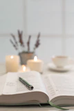 An open e-book on a tablet displaying journaling prompts with a cup of tea nearby.