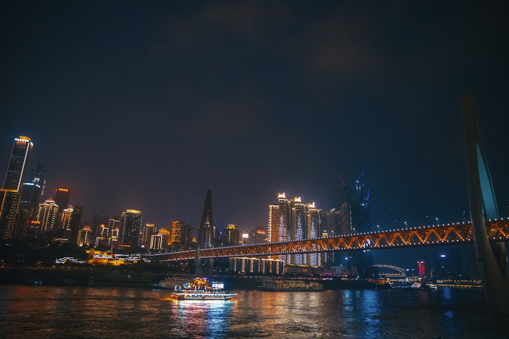 lighted bridge over river during night time