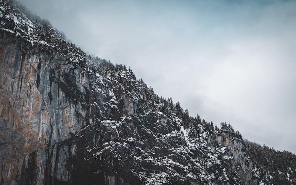 gray and brown rocky mountain under white cloudy sky during daytime