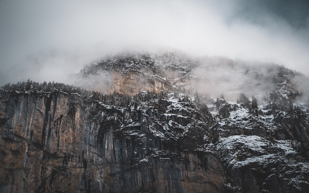 brown rocky mountain with white clouds