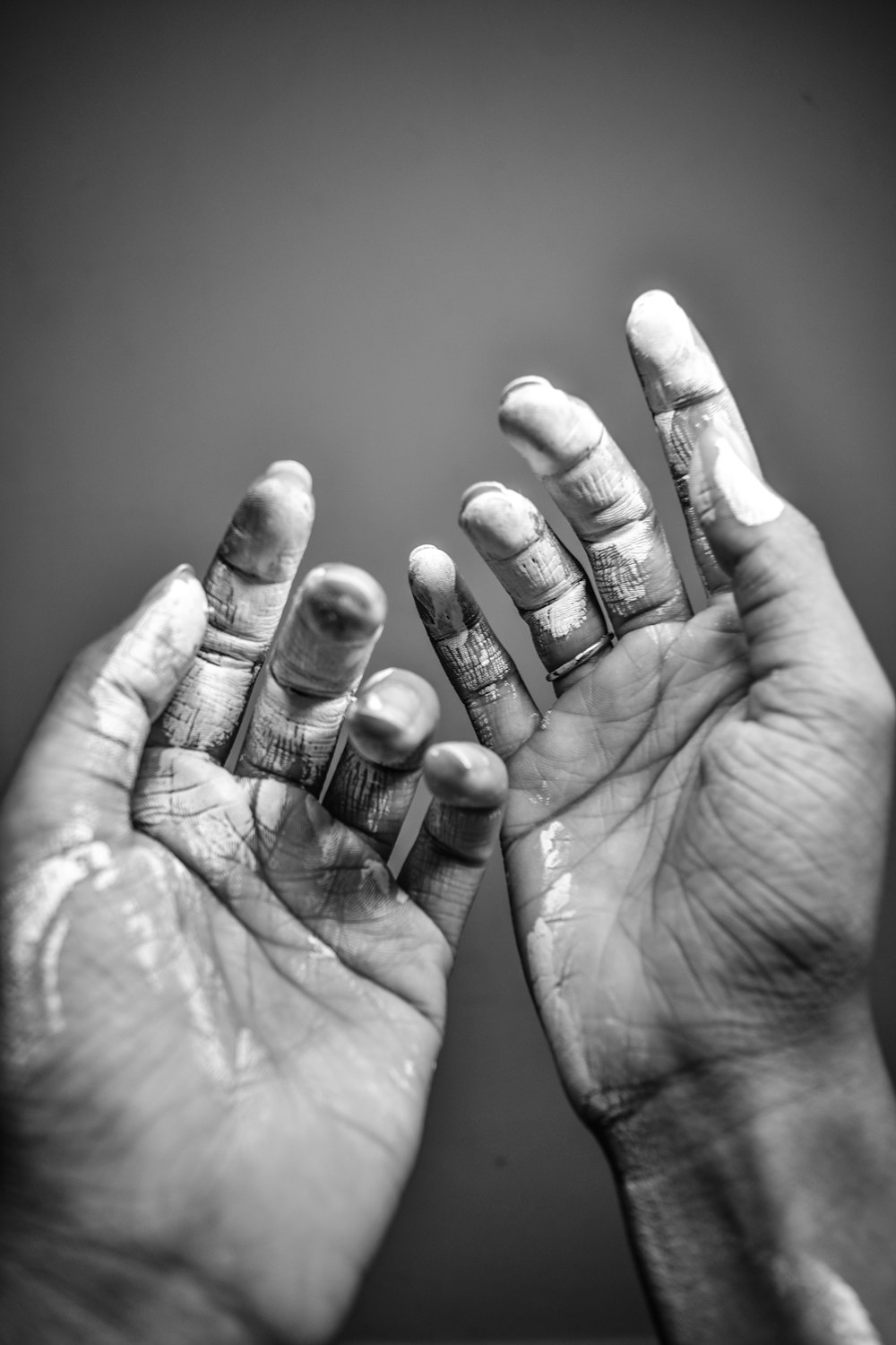 grayscale photo of persons hand with manicure