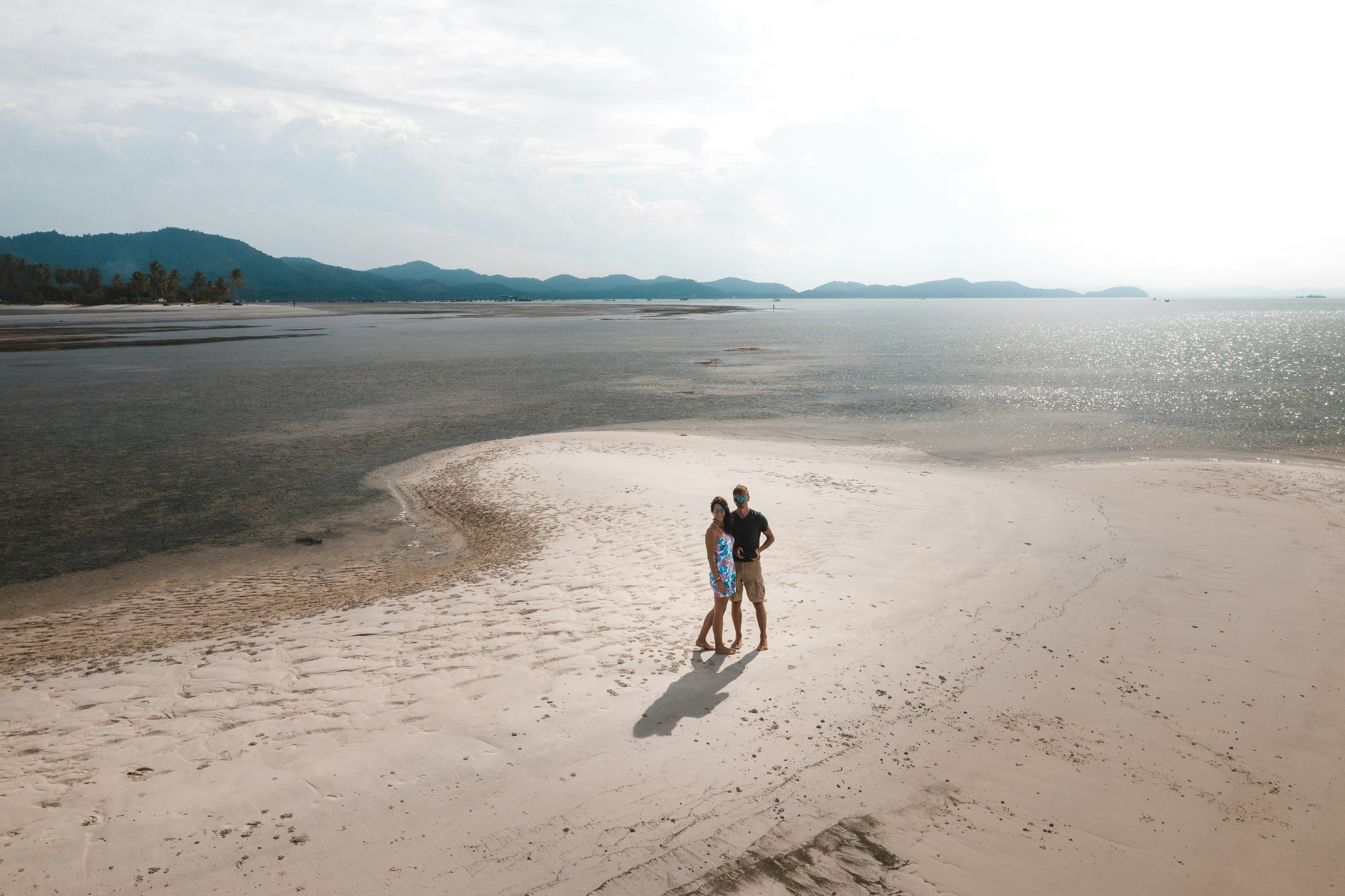 2 women walking on beach during daytime