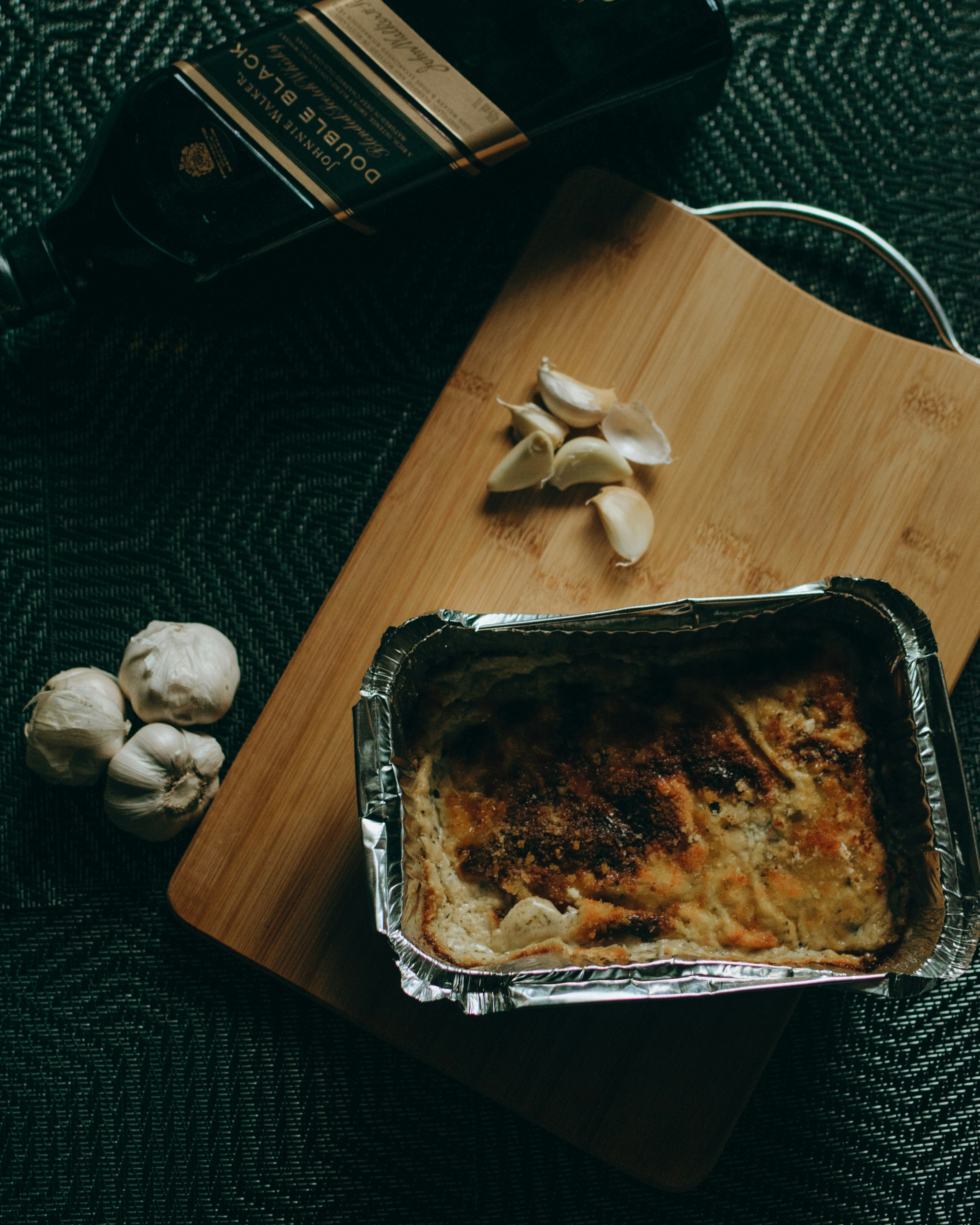 black plastic tray with food on brown wooden table