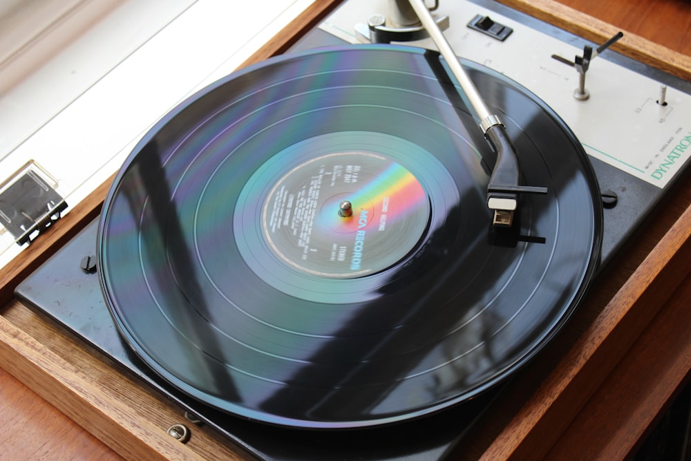 black vinyl record on brown wooden table