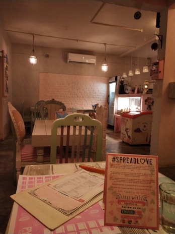 A cozy cafe interior featuring pastel decor and comfortable seating arrangements.