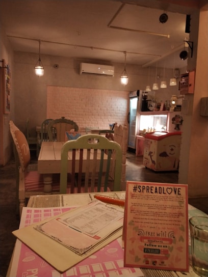 A warm, inviting cafe interior with soft #e9dfd3 walls and rustic #724025 wooden accents, filled with happy young customers.