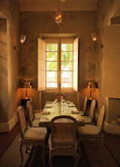 Elegant dining room with a bespoke wooden table and soft ambient lighting.